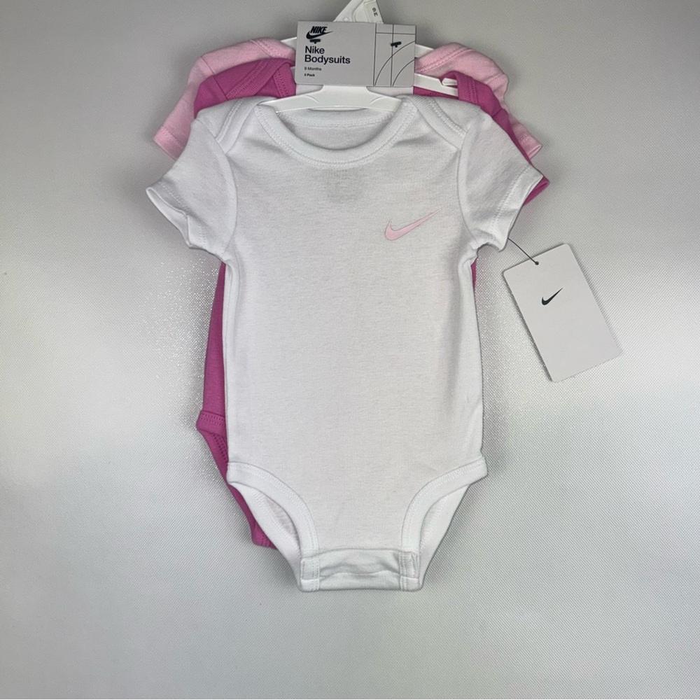 Nike 3 pack short sleeve onesies.  Baby pink, hot pink and white. 9 months NWT